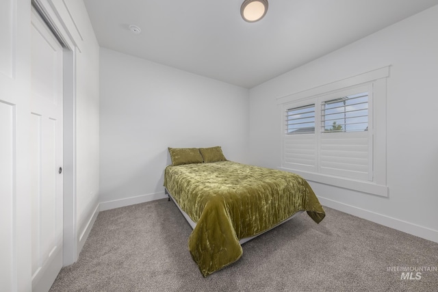 bedroom featuring carpet flooring and baseboards