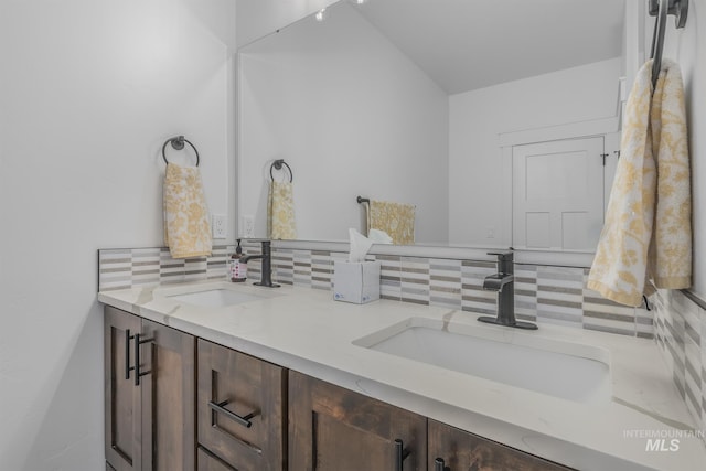 bathroom featuring tasteful backsplash and double vanity