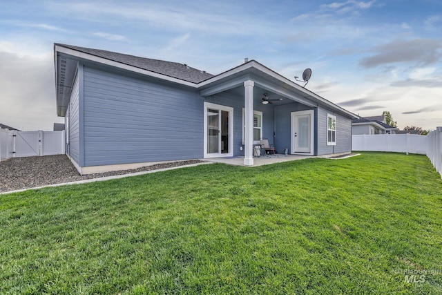 back of house featuring ceiling fan, a patio area, and a gate