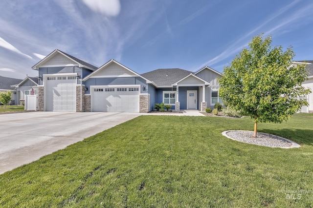craftsman house featuring stone siding, a garage, a front yard, and driveway