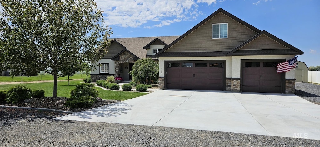 127 S 160 W, Jerome, ID 83338 - craftsman-style house featuring stone siding, concrete driveway, and a front lawn