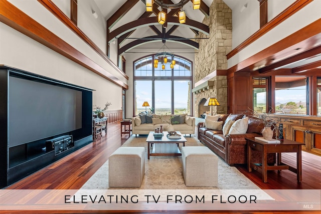 living room featuring hardwood / wood-style flooring, high vaulted ceiling, and plenty of natural light