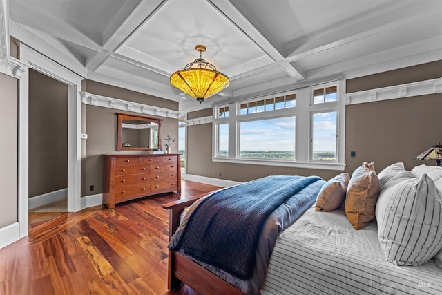 bedroom featuring hardwood / wood-style flooring, beam ceiling, and coffered ceiling