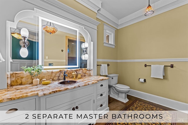 bathroom with vanity, toilet, and ornamental molding