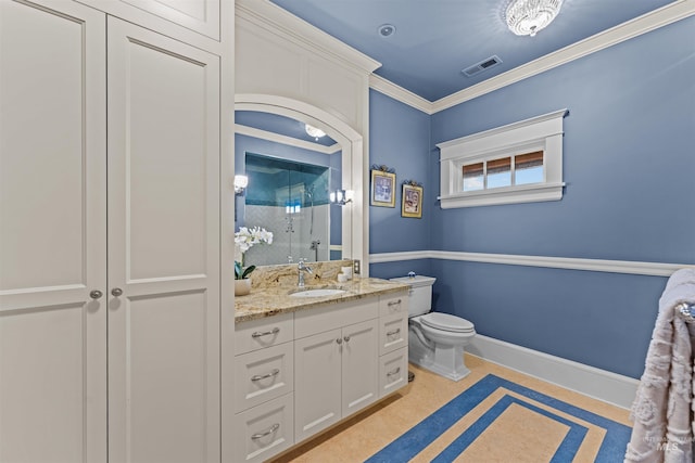 bathroom with toilet, vanity, ornamental molding, and walk in shower