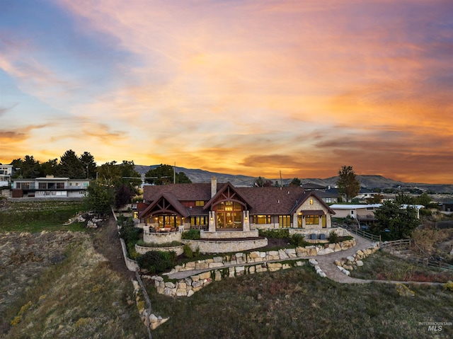 back house at dusk featuring a mountain view