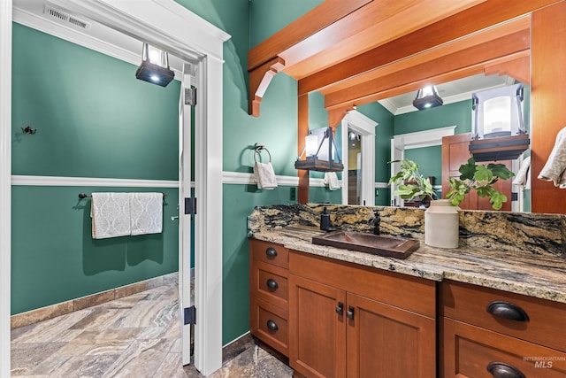 bathroom featuring vanity and ornamental molding