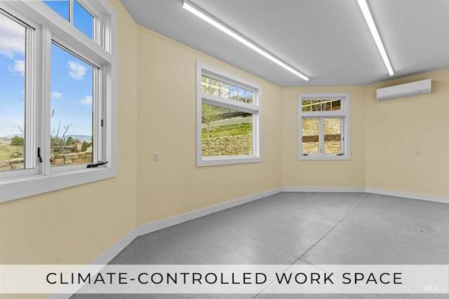 spare room featuring a wealth of natural light and a wall mounted air conditioner