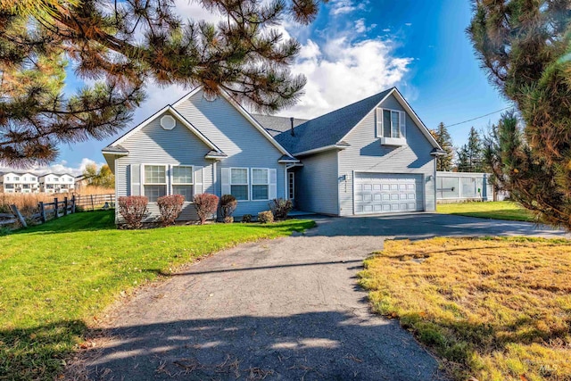 view of front property with a front yard and a garage