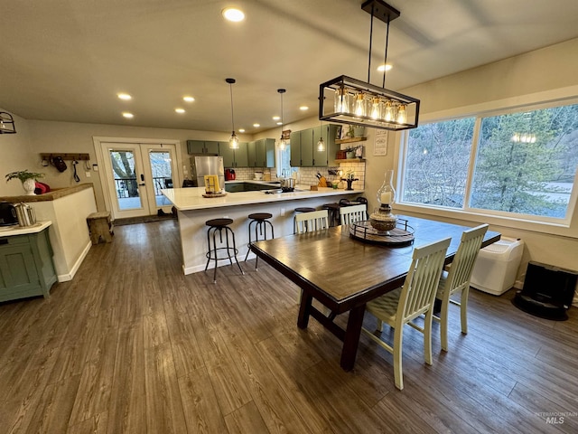 dining space with recessed lighting, french doors, and dark wood finished floors