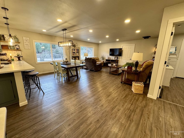 dining space featuring dark wood-style floors, baseboards, and recessed lighting