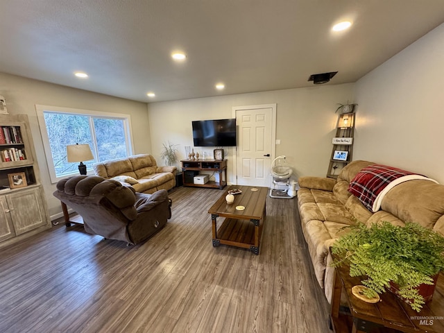 living room with recessed lighting and wood finished floors