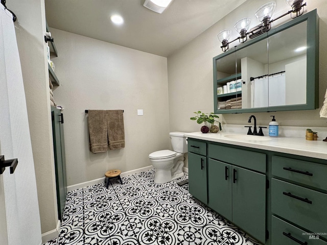 bathroom featuring toilet, recessed lighting, vanity, baseboards, and tile patterned floors