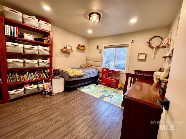 bedroom with wood finished floors and recessed lighting