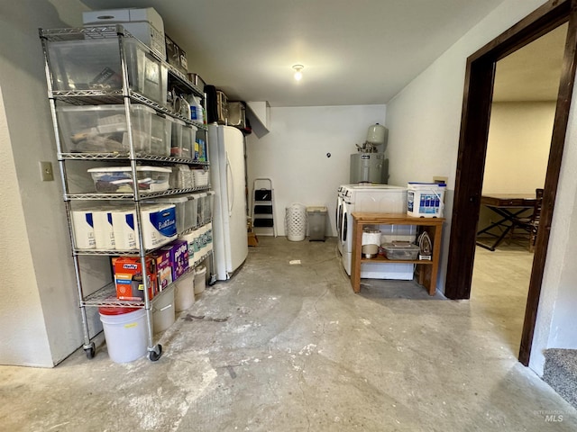 storage room with washing machine and dryer and electric water heater