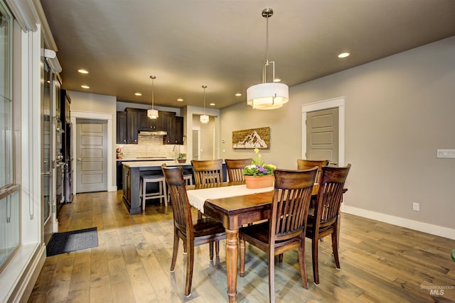 dining room featuring recessed lighting, baseboards, and hardwood / wood-style floors