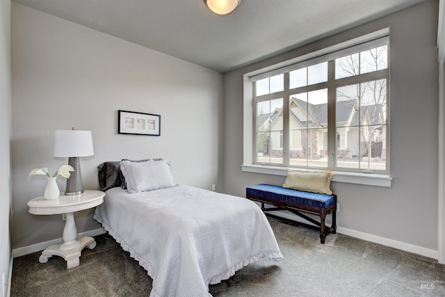 carpeted bedroom featuring baseboards