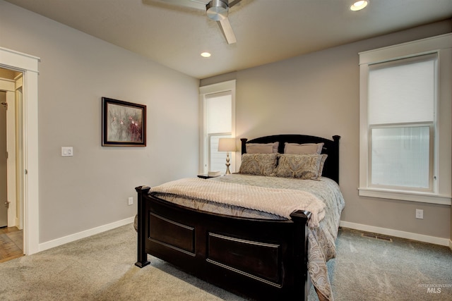 bedroom with carpet floors, visible vents, and baseboards