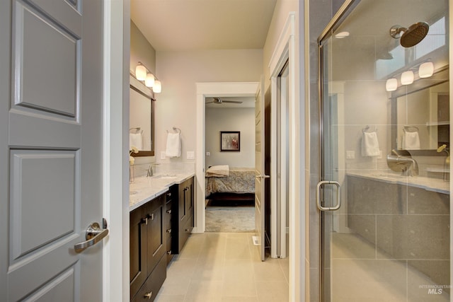 ensuite bathroom featuring connected bathroom, a shower stall, and vanity