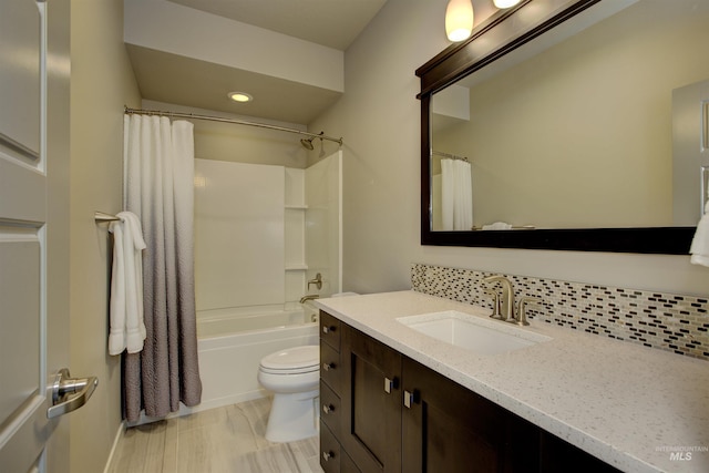 bathroom featuring shower / tub combo with curtain, toilet, backsplash, and vanity