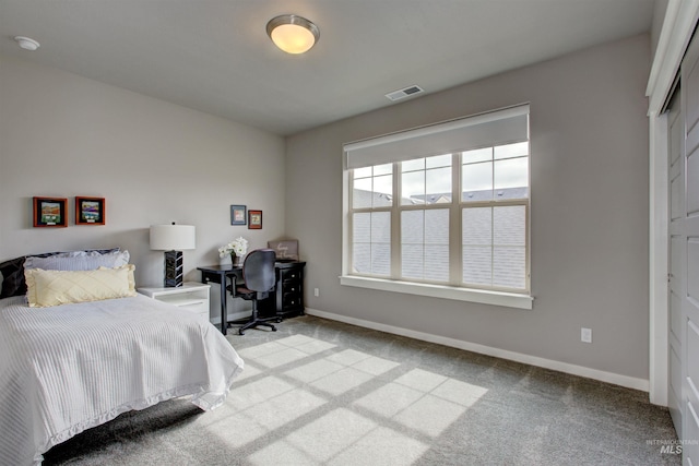 carpeted bedroom featuring visible vents and baseboards