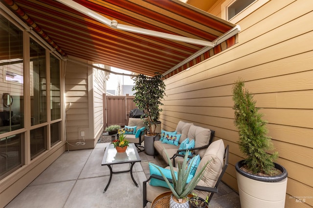 view of patio featuring fence and an outdoor living space