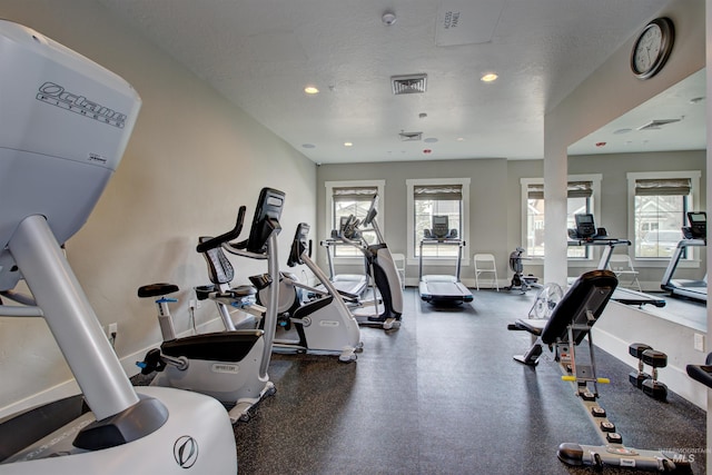 gym with baseboards, visible vents, a textured ceiling, and recessed lighting