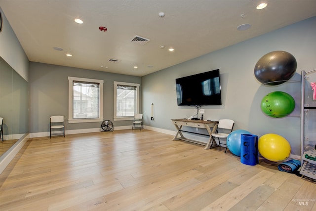 exercise room featuring baseboards, wood finished floors, visible vents, and recessed lighting