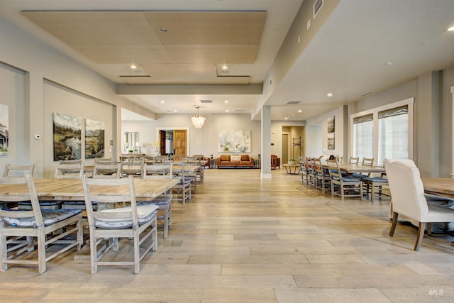 dining area with light wood finished floors, visible vents, a notable chandelier, and recessed lighting