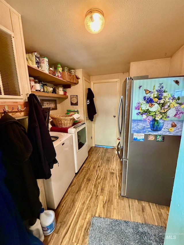 103 Beech St, Nezperce, ID 83543 - laundry room featuring separate washer and dryer, laundry area, light wood-style floors, and a textured ceiling