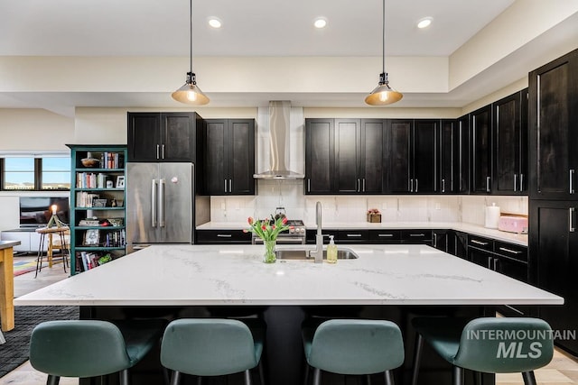880 W River St, Boise, ID 83702 - kitchen with wall chimney range hood, stainless steel appliances, decorative backsplash, and a sink