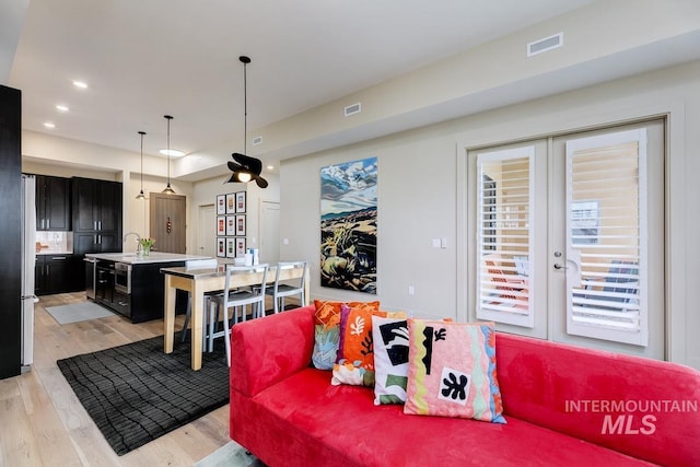 880 W River St, Boise, ID 83702 - living room featuring visible vents, recessed lighting, french doors, and light wood-type flooring