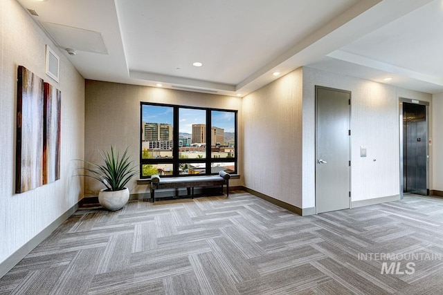 880 W River St, Boise, ID 83702 - interior space featuring visible vents, light colored carpet, baseboards, elevator, and a tray ceiling