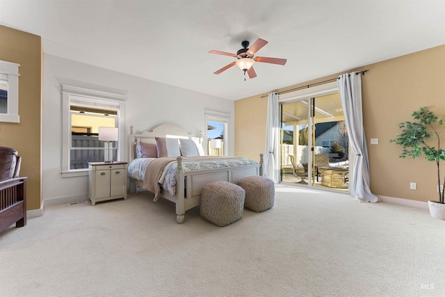 carpeted bedroom featuring ceiling fan, access to exterior, and multiple windows