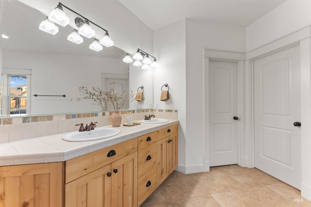 bathroom with decorative backsplash, tile patterned floors, and vanity