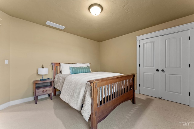 carpeted bedroom featuring a closet