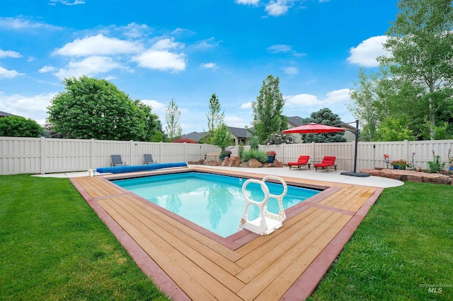 view of swimming pool featuring a patio area and a lawn