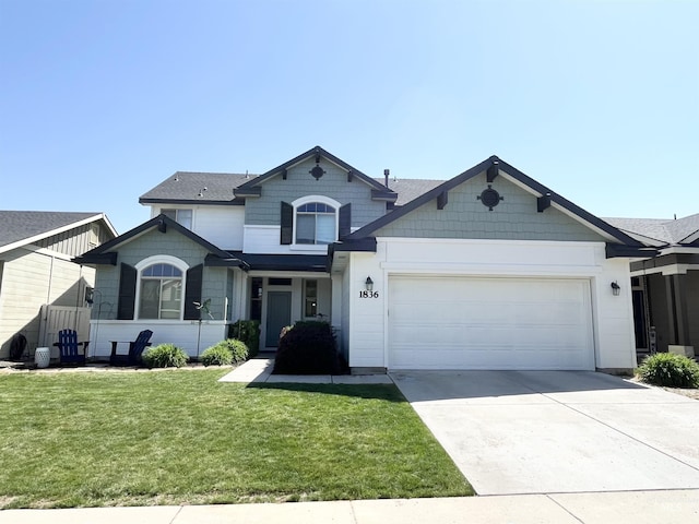craftsman inspired home featuring a garage, driveway, and a front yard
