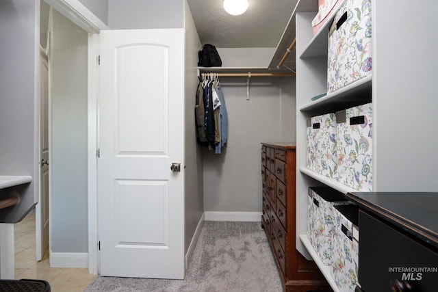 walk in closet featuring light tile patterned flooring