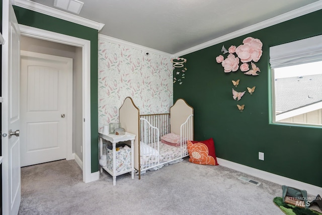 carpeted bedroom with ornamental molding and baseboards