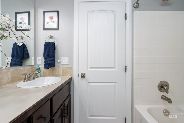 bathroom with vanity and shower / tub combination