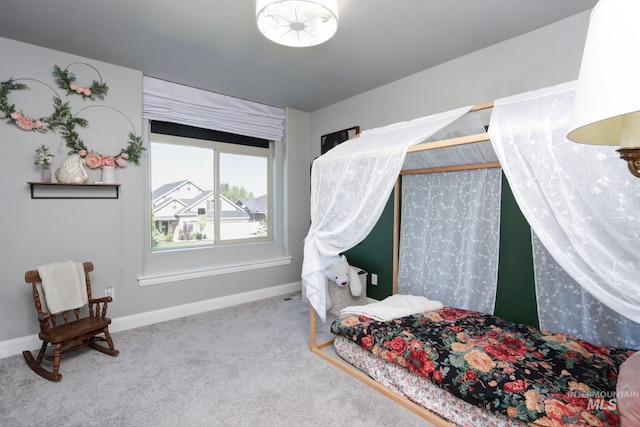 carpeted bedroom featuring baseboards