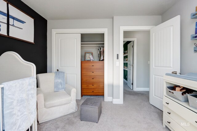 sitting room featuring light carpet and baseboards