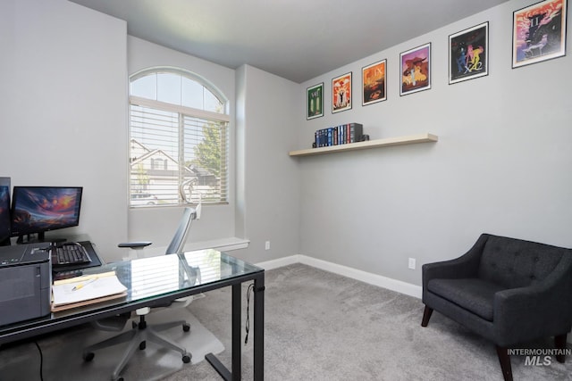 carpeted office featuring baseboards