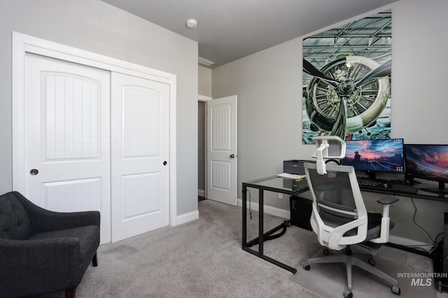 carpeted office featuring baseboards