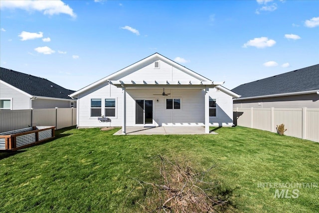 back of house with a lawn, a patio, and ceiling fan