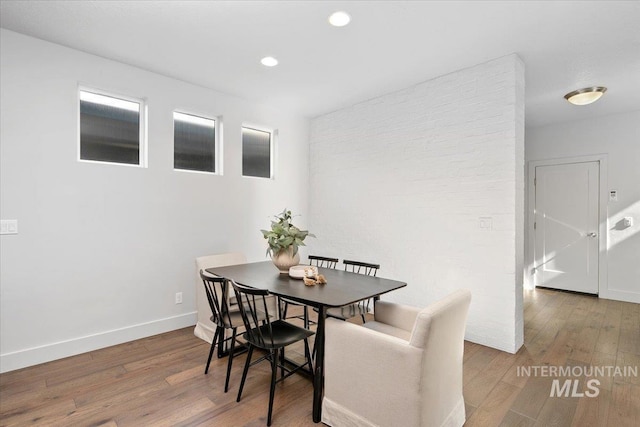 dining space with recessed lighting, baseboards, and wood finished floors