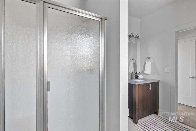 full bathroom featuring a stall shower and vanity