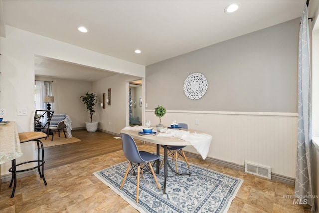 dining area featuring wainscoting, recessed lighting, and visible vents