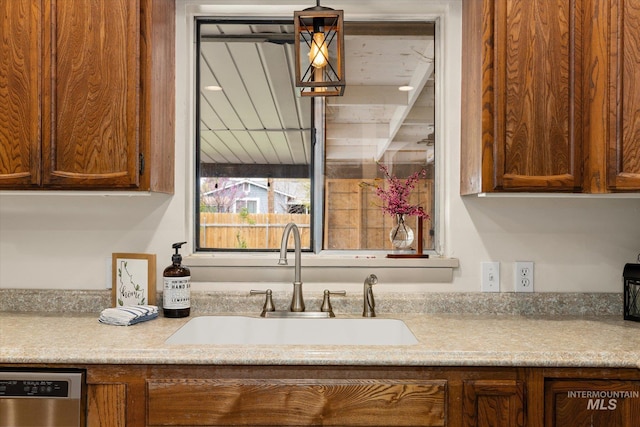 kitchen featuring a sink, light countertops, and stainless steel dishwasher